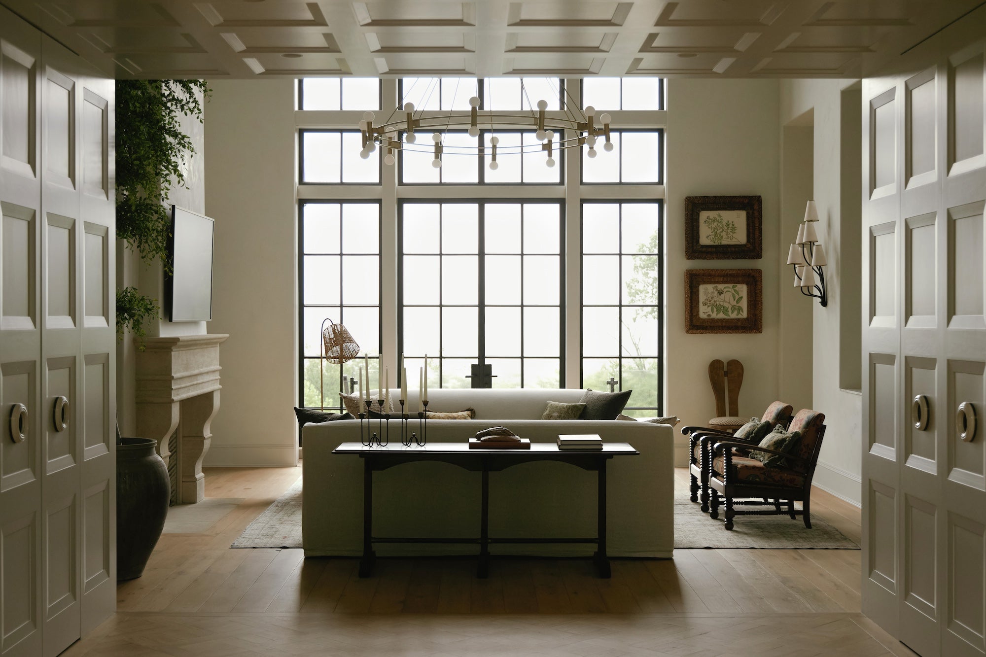 An image of a living room with floor-to-ceiling black windows.
